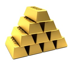 Pile of gold bars stacked in a pyramid isolated over white