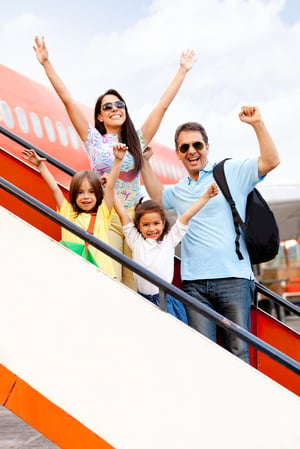 Happy family going on holidays and getting on the airplane